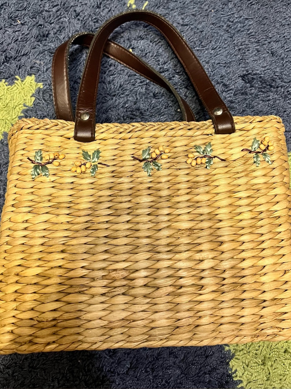 Woven Straw Tote Bag with Brown Handles and Yellow Berry Accent